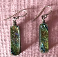 Front view of the pair of rectangular dichroic glass sterling silver earrings showing their size, shape and color.