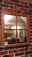 Front view of wooden framed mirror designed to look like a window with four panes.