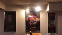 Wide view showing three framed movie posters side by side on a wall: The Maltese Falcon, Casablanca, and Raging Bull