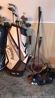 Overview showing golf bag, clubs and tennis racquets