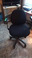 Front view of black Borgo swivel office chair on wheels with cushioned seat and backrest, fabric upholstery.