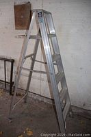 Full view of the Reynolds 5 step aluminum ladder standing open on the ground indoors, showing the steps and platform.