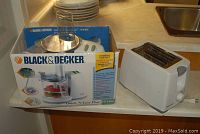Photo showing the Black & Decker food processor in original box and the bagel toaster on the counter.