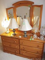 Front and top view of pine dresser with mirror and lamps on top, showing dresser top surface and mirror details