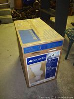 Angled view of unopened cardboard box showing Glacier Bay logo and product graphics