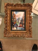 Overview of framed enamel on copper painting depicting an urban scene with people, bus, and domed building.