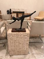 Front view of dancer statue atop pedestal