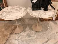 Pair of round marble top side tables displayed side by side