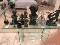 Full view of the lot on glass shelf showing all ten items.