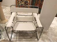 Front view showing chrome frame and white leather seat and back