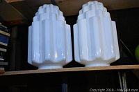Two white opaque Art Deco style glass light covers, stepped geometric design on top shelf