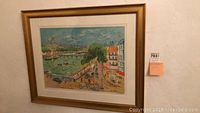 Front view of framed artwork showing the full image of a scenic city river view with vibrant colors