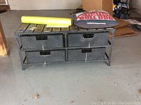 Mud room storage bench with four metal drawers, pillow, and mat on top, showing overall lot content and condition.