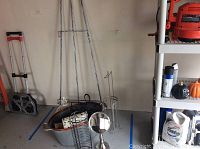 Overview photo showing galvanized metal bin holding various items next to a 54-inch metal easel, a metal cage basket, a round metal mirror with stand, two metal toilet paper holders, and a dolly.