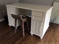 Front left side view showing two small drawers, cabinet door storage and bun foot