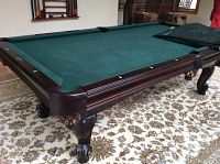 Full view of Brunswick pool table showing frame, felt surface and legs