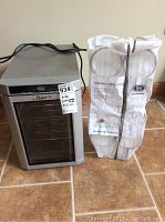 Danby Maitre'D wine refrigerator next to boxed Hooker countertop wine rack on tile floor
