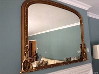 Full view of mirror mounted on wall showing overall shape and frame detail