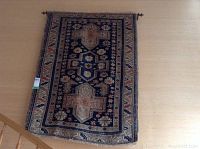 Full view of the hanging rug mounted on a rod