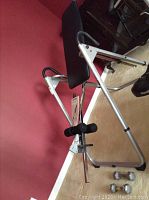 Photo of Kettler Apollo inversion table with padded backrest and silver frame setup on carpeted floor.