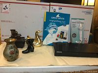Full lot showing Samsung Blu-ray player, ceramic decor, office supplies