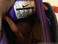 Close-up photo of the size and label tag inside the sneaker showing size US 4Y, UK 6, EUR 40, made in Indonesia