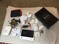 Overview of all items including AT&T U-verse modem, sensors, detectors, pouch, and tools.