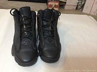 Front view of black Nike Kids Air Jordans, showing laces, tongue and toe area.