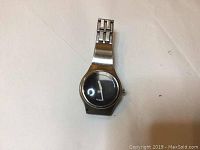 Men's Fossil wristwatch with metal band, black face, watch crown on right side, showing wear and some scuffs.