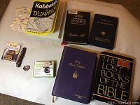Photo showing a layout of six books including religious titles and self-help, a snore stopper device, navy pin, butterfly patch, small black cube, and a BBON Bows accessory kit.