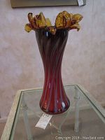Full view of the tall amberina colored Venetian Murano art glass vase showing its shape, height and coloration.
