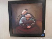 Full view of the framed square painting showing the couple and bird composition in warm muted colors with black frame