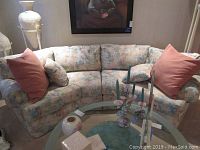 Full front view of the two-piece sectional sofa with abstract watercolor fabric and pillows.