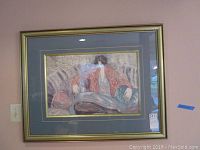 Full framed painting showing woman seated on a couch in a red robe with blue and gold double mat and gold frame