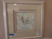 Full photo of the framed seashell wall art showing the 23 inch square frame and the seashell arrangement inside.