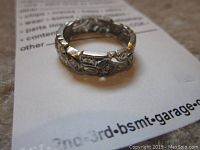 Top-down view of ring showing filigree openwork design and milgrain edges