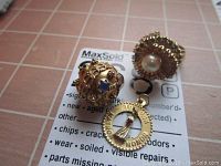 Three pieces displayed on MaxSold card: spherical filigree charm, Matron of Honor pendant, cocktail ring.