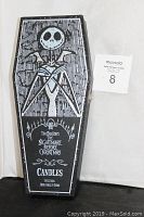 Closed black coffin box with white graphic of Jack Skellington and text identifying it as a Nightmare Before Christmas candle set with Jack, Sally, and Zero candles inside.