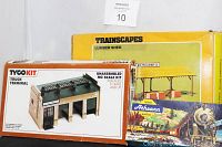 Boxes of the train toy lot including Trainscapes Lumber Shed, Tyco Kit Truck Terminal, and Athearn packaging.