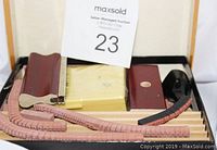 Set of rubber stamp components with rulers, stamping pads and a maroon handle, contained in a tray with catalog card