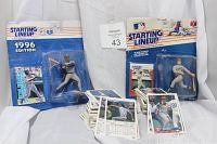 Two Starting Lineup baseball action figures in original packaging, Jose Canseco 1996 edition and Rondell White, accompanied by a large pile of baseball cards.