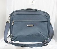 Front view of the royal blue Dakota carry-on case showing the zippered front compartments and attached shoulder strap.