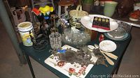 Overview of the table showing various serving items, decorative pieces, candle holders, and glassware arranged together.