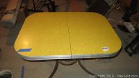 Top view of a yellow Formica vintage table showing the surface and edges.