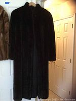 Full view of the vintage black mink fur coat showing length and texture.