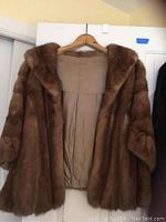 Front view of vintage brown mink stole with open front showing beige hand-stitched lining.