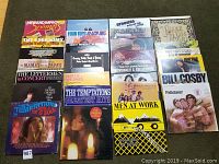 Top-down close view of a portion of the LP records showing The Bee Gees, The Temptations, Men at Work, Bill Cosby and others.