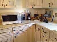 Kitchen counter with Sharp microwave and Cuisinart food processor