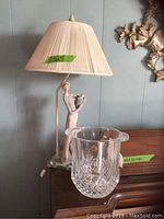 Photo showing Lladro lamp with figurine and crystal ice bucket in front