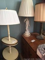 Vintage two tier table lamp with attached lamp and other lamps on wooden dresser